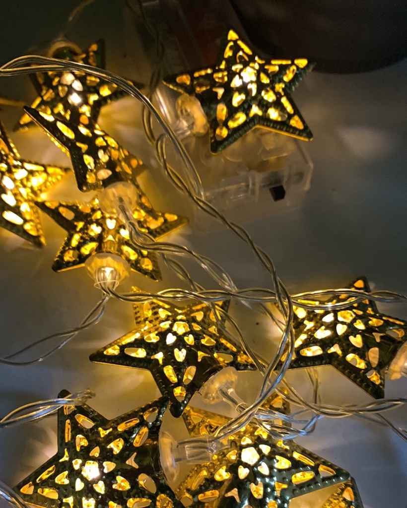 A string of lights shaped like gold stars.