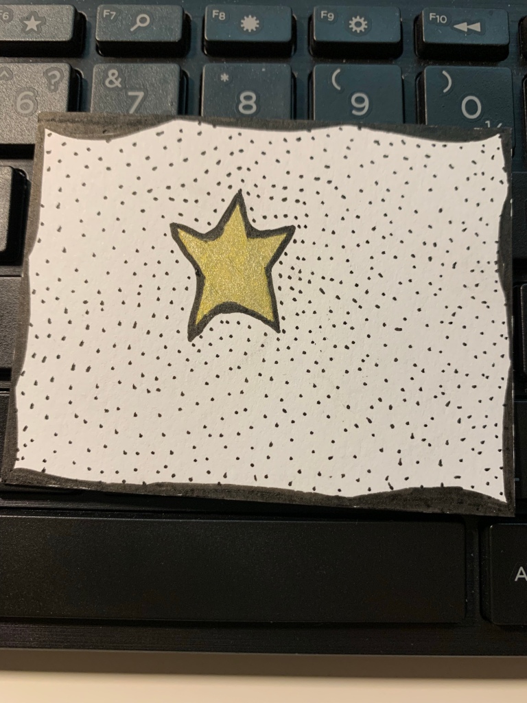 a small drawing of a gold star surrounded by black dots