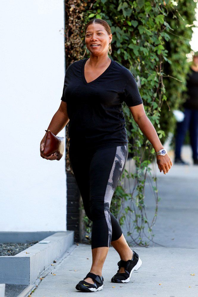 QL on a warm day in capris and dark v-neck T, Mary Jane style active shoes.