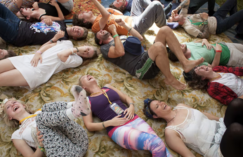 People lying on the floor together, laughing.